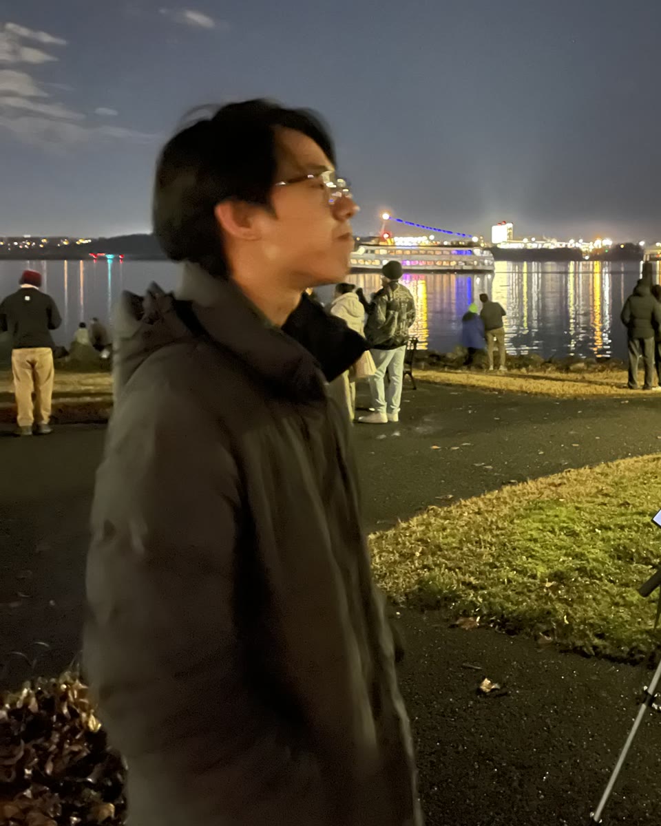 Tianyi Zhou by the waterfront at night